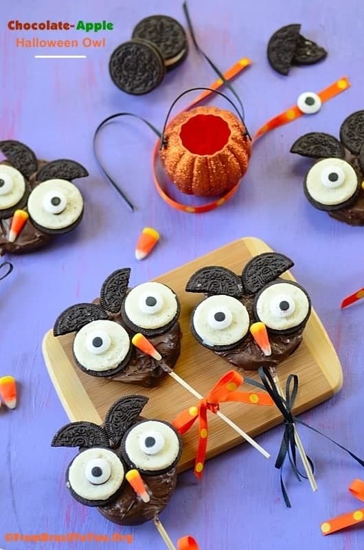 Chocolate Apple Halloween Owl over a table with garnishing on the side