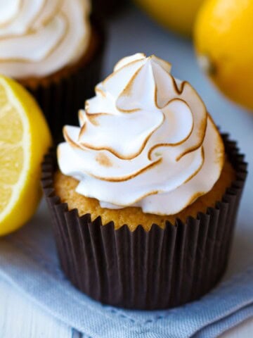 Lemon meringue cupcakes with some lemons around them!