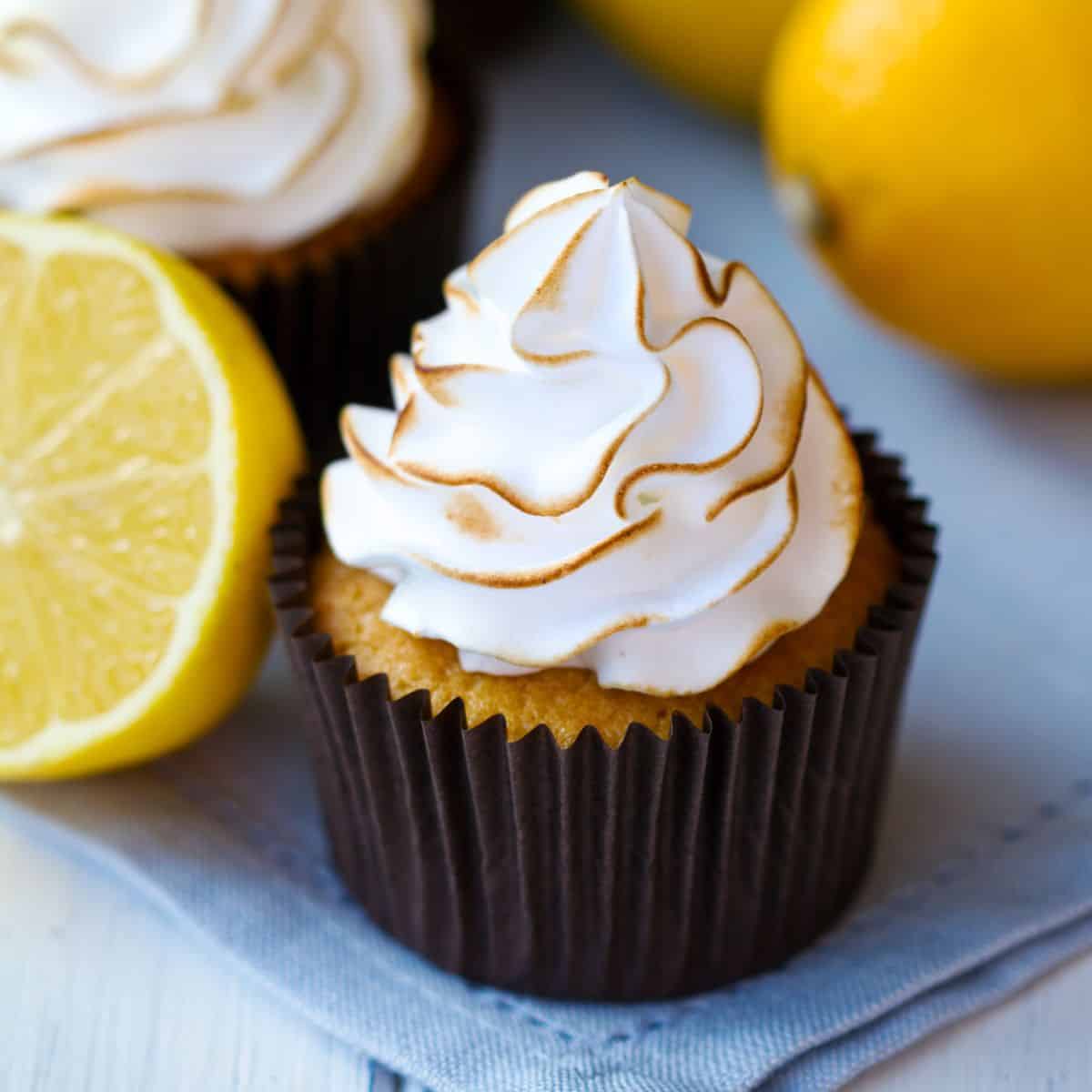 Lemon meringue cupcakes with some lemons around them!