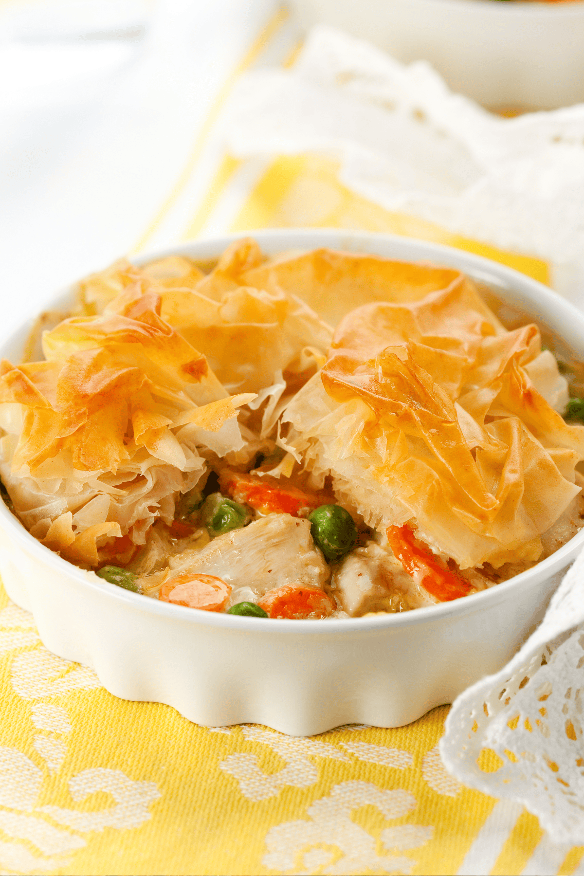 Phyllo chicken pot pie in a baking dish, partially eaten.