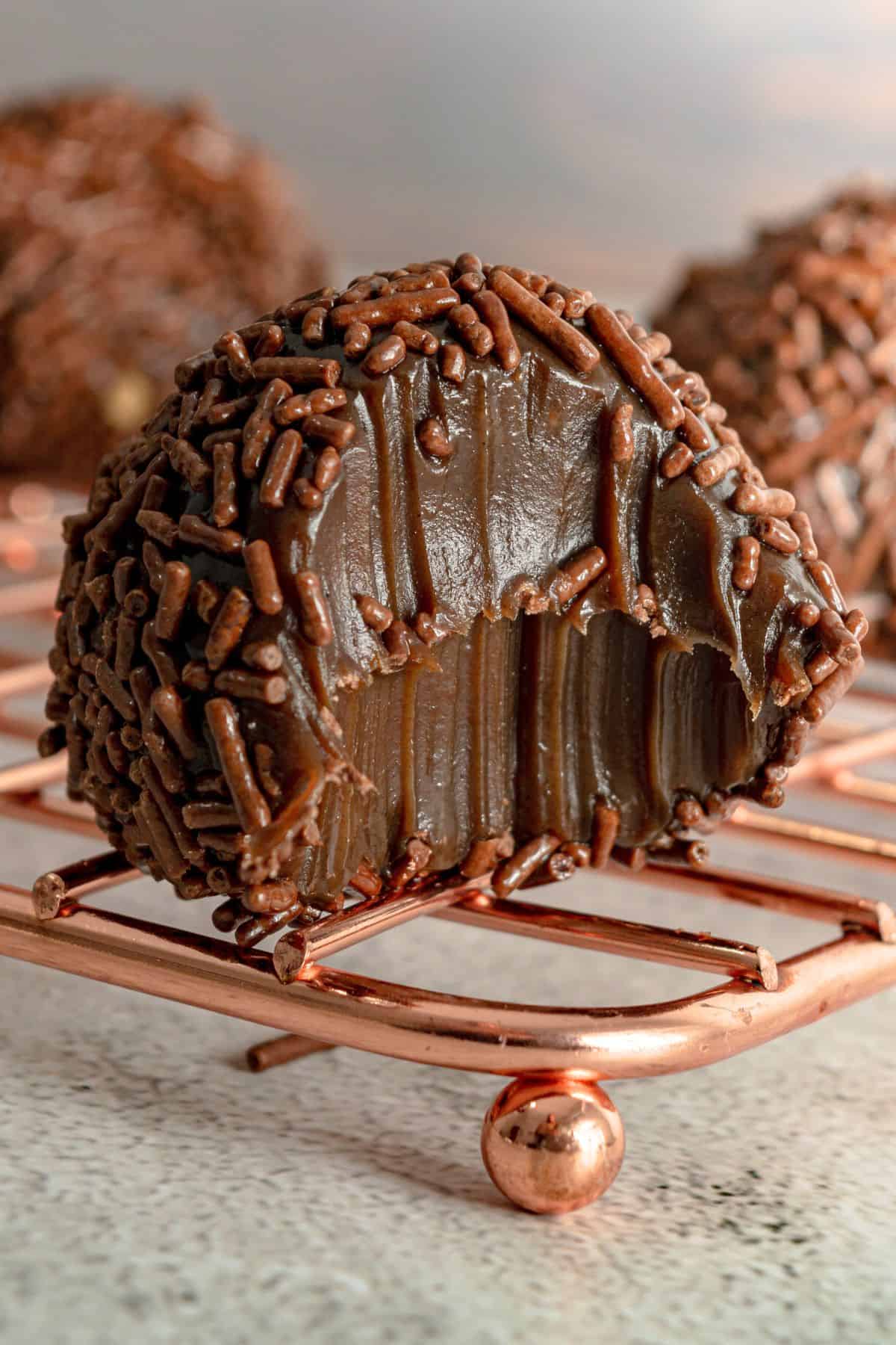 Close up of a Brazilian chocolate ball on a rack.