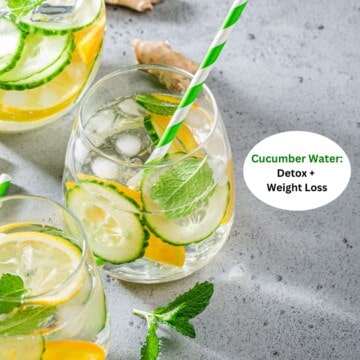 Several glasses of cucumber water with cucumber, lemon, mint, and ginger on a table.