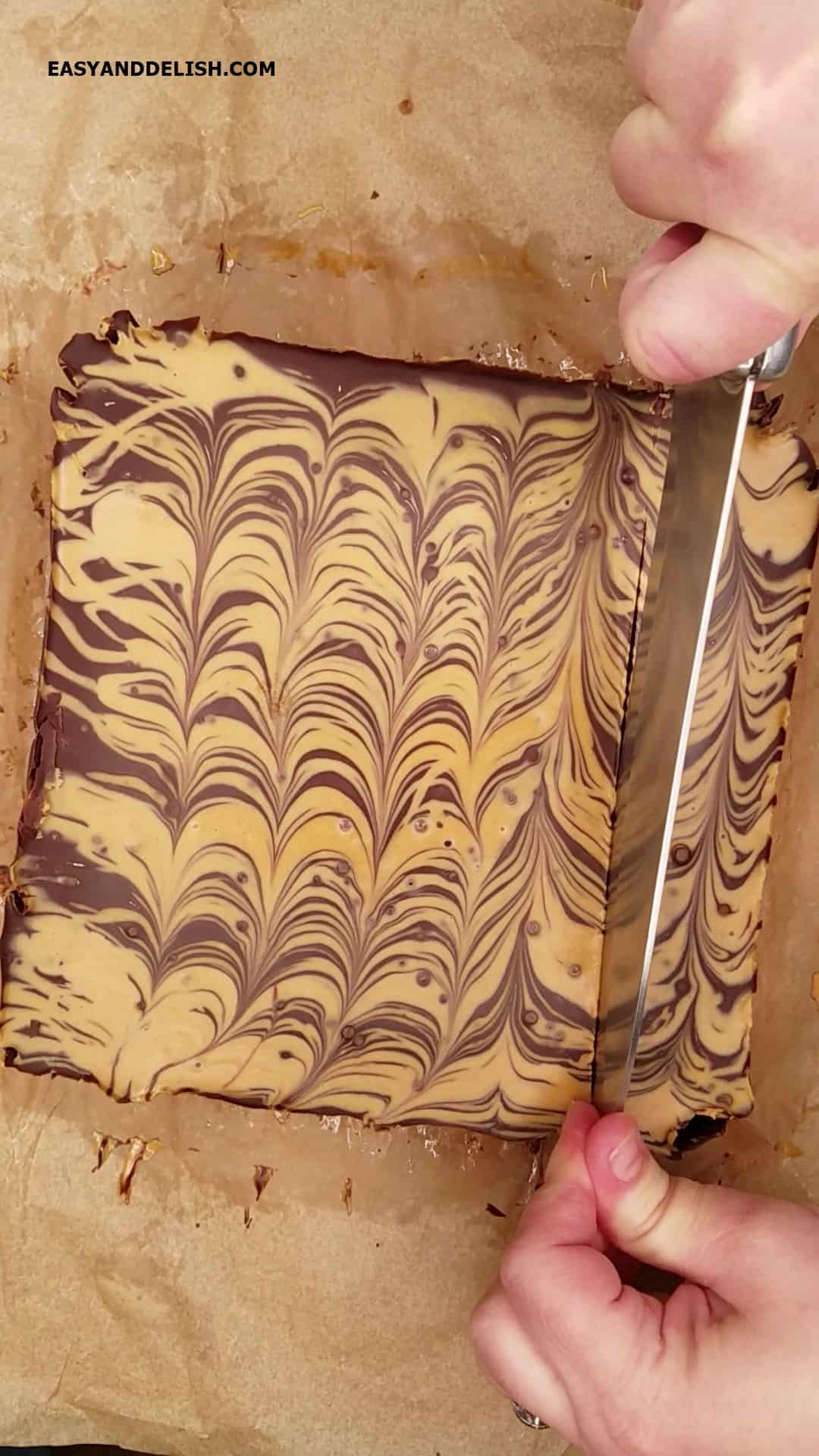 Slicing no-bake chocolate peanut butter crunch bars.