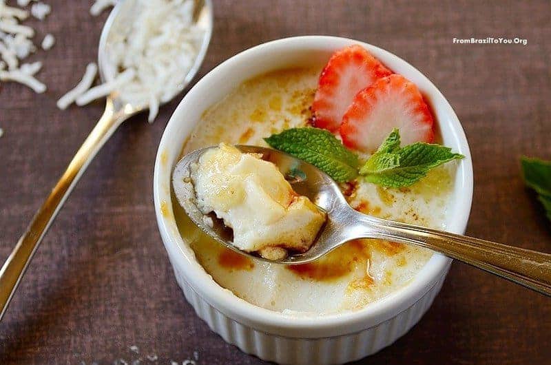 A tropical no-bake dessert in a ramekin with a spoon on top and another on the side. 